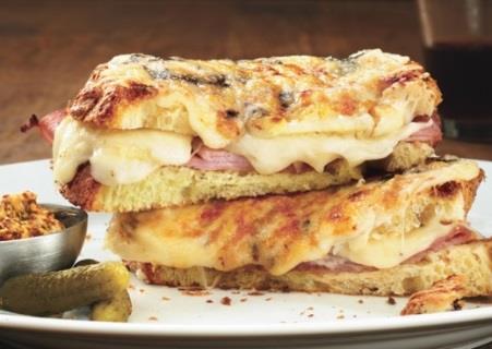 CROQUE MONSIEUR Serves 4 8 slices wholemeal bread 3oz grated cheese 4 slice of ham 1 ½ oz butter Make 4 sandwiches with bread cheese and ham, butter outside of sandwich, place on baking tray