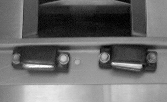 Using 2 self tapping hex head screws, attach the magnetic door catch in the 2 holes in the bottom of the grill. (Repeat for second door catch) (See Fig. 6) Bolts 3.
