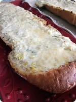 CHEESY ARTICHOKE BREAD S I D E D I S H Serves: 12 Prep Time: 10 Minutes Cook Time: 20 Minutes 1 (14 ounce) can artichoke hearts (drained and chopped) 2 green onions (sliced) 2 teaspoon minced garlic
