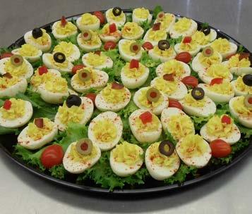 Deviled Egg Delectable deviled eggs topped with a variety of colorful garnishes.