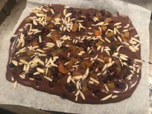 with baking paper In a microwave proof bowl place the chocolate that has been chopped or broken up, with the exception of approximately 1 row (30-50g) with the coconut oil Place in the microwave for