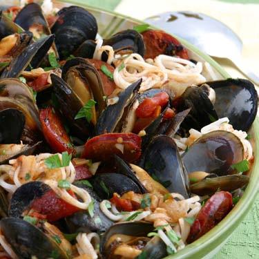 Mussels with Linguica Rice pasta soaks up all the varied flavors of this Portuguese style entrée. It makes a stunning presentation as a main course, or served in individual bowls for a starter course.