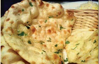 00 Bread, baked in a tandoor oven with basil & fresh minced garlic on top Himalayan Kitchen Special Naan... $5.