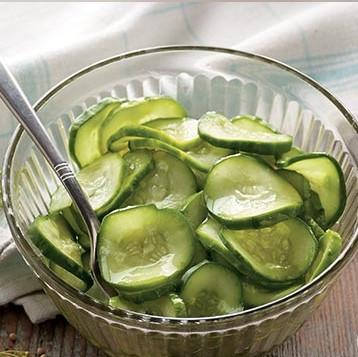 Attach cucumbers to food guider and place at top of Mandoline and push down to slice. Once sliced, cut in half. Set aside. 3.