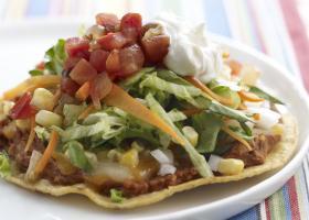 Eagle Pizza Makes: 6 Tostada Pizzas A delicious combination of pizza and taco, this recipe is made with whole-grain tostada shells, refried beans, shredded cheese, and a stack of colorful veggies.