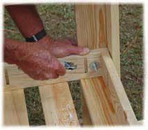 Place a bolt through the table and the side leg stud and secure from the inside using a