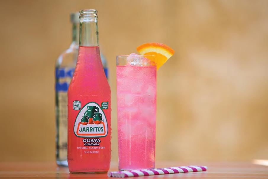 PINK PASSION Tall glass filled with ice 45ml Vodka Jarritos Guava Slice of orange Fill glass