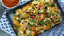 Ultimate Nachos Yields: 6 servings Ingredients 2 bags of good quality tortilla chips 1 chicken breast, cooked 1 large handful of cilantro, plus extra for garnish 1 lime (optional additional lime for