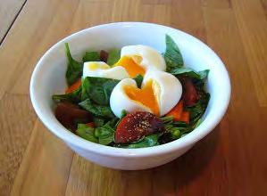Mix together olive oil, balsamic vinegar and mustard. Toss through salad. When eggs are cooked, peel and cut in half, place on salad to serve.