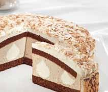 White chocolate flakes sprinkled with sifted cocoa powder complete this gateau fit for a gourmet.