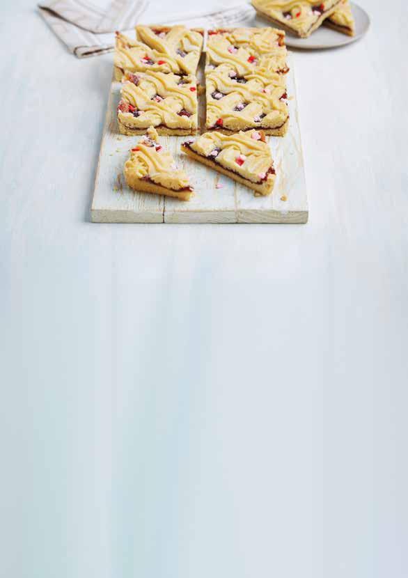 LOVED UP TREATS Viennese Traybake (7038) Serves 12 Rich shortbread base topped with fruity raspberry jam