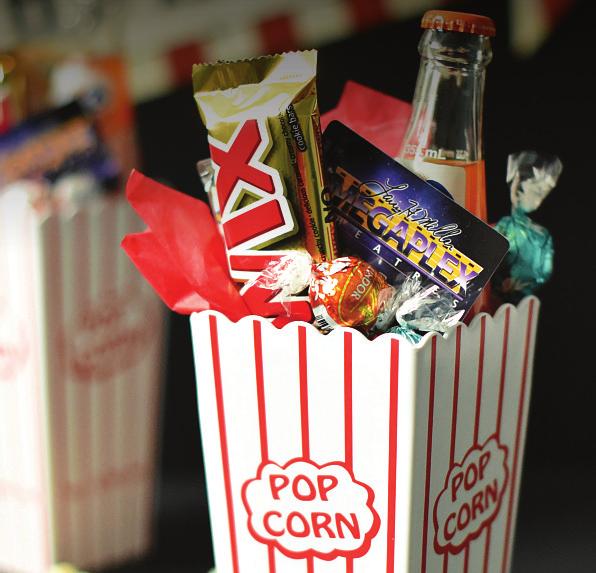 Movie Night Gift Bucket Plastic Popcorn Container Favorite Movie Candy Microwave Popcorn Favorite Soda Movie ticket(s) White Basket Filler or tissue paper Ribbon/name tag 1.