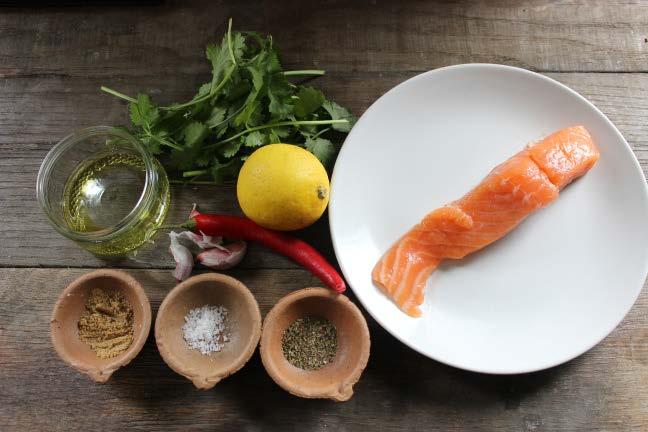 Mix the chilli, oil, garlic, ground coriander, basil, salt and lemon in a large bowl. Place the salmon fillet in the bowl and carefully turn in the mixture to cover thoroughly.