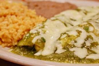 95 Enchiladas Verdes Two chicken enchiladas topped with tomatillo sauce and Monterey jack cheese, served with Mexican rice and refried beans 10.
