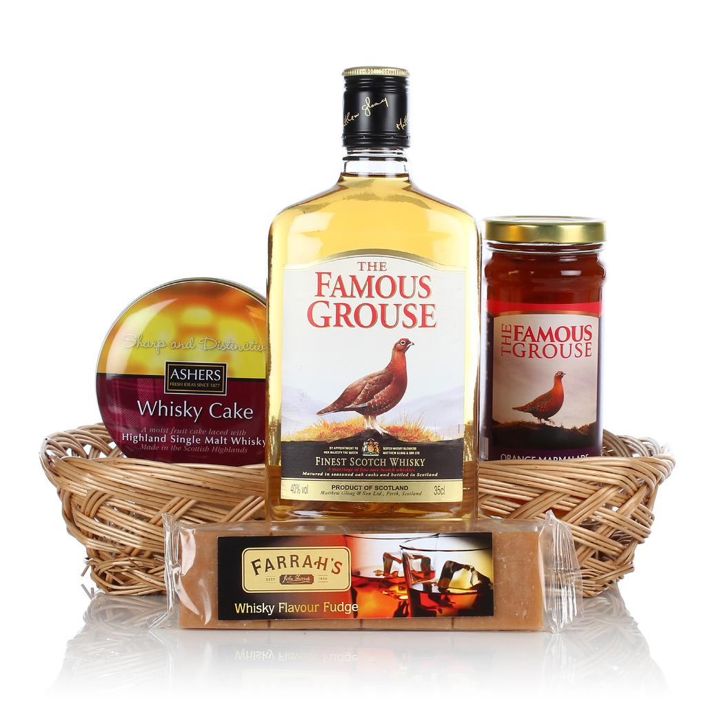 WHISKY LOVERS GIFT Presented in an open weave tray containing: Ashers Highland Single Malt Whisky Cake in Tin 180g Farrah s Harrogate Whisky Fudge Bar The Famous Grouse Orange Marmalade 340g The