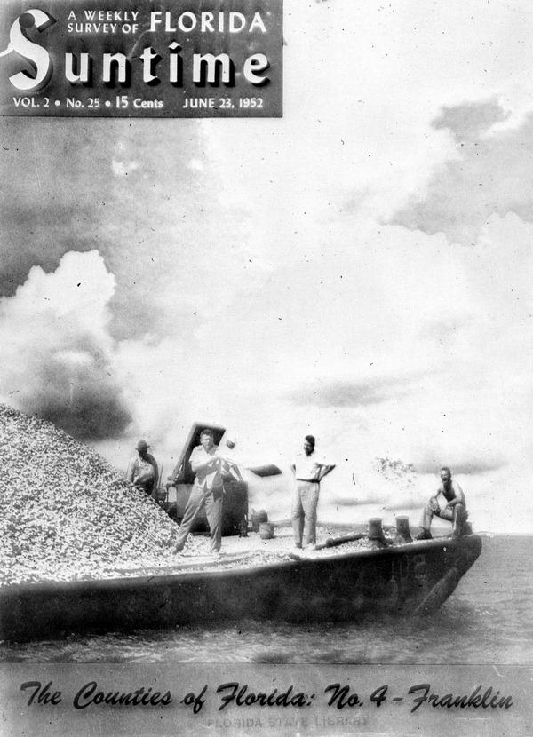 Robert Ingle shoveling oyster cultch from a barge