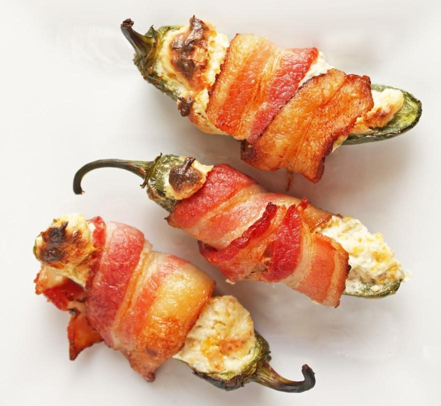 STARTERS BACON WRAPPED JALAPENOS Fresh jalapenos stuffed with cream cheese, pulled pork then wrapped in bacon and baked. Highly addictive, and amazing! 10.