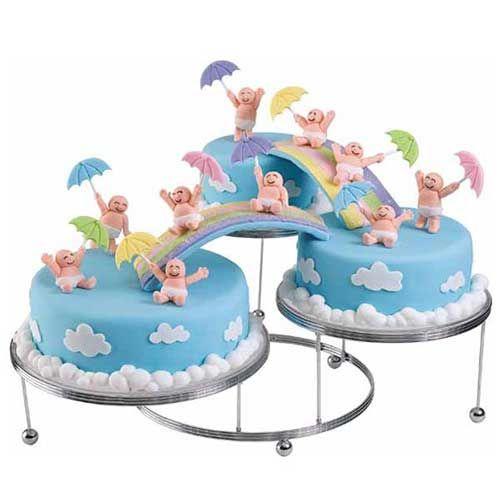 These cute little babies waiting for the shower downpour situated on a tri-level tiered cake stand! From the rainbows to the clouds, and even the babies all is made from fondant!