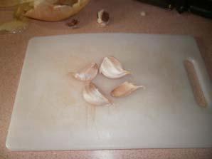 Take the four garlic cloves to the cutting board and