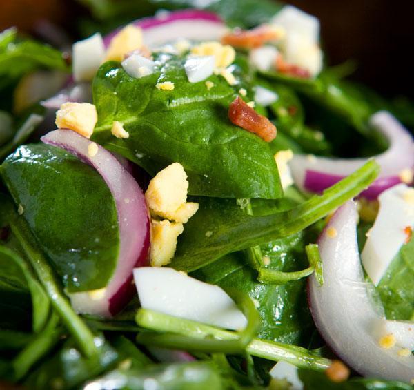 Wilted Spinach Salad with Hot Bacon Dressing Bacon, cut into small strips Yellow or White Onion, cut small dice Sugar Water Vinegar Fresh Baby Spinach Red Onion Egg, Hard Boiled Bacon Bits (cooked) 1.