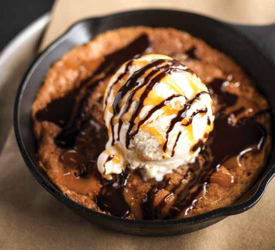 SALTED CARAMEL COOKIE SKILLET SWEETS APPLE COBBLER DESSERT FLATBREAD Loaded with spiced granny smith apples and house-made streusel, baked to perfection, finished with caramel sauce & powdered sugar