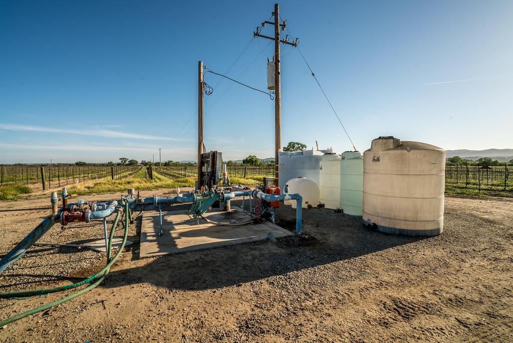 Irrigation and Well Reports The vineyard is entirely drip irrigated and the irrigation pad includes fertilizer tanks, injection ports, backflow