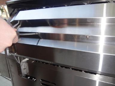 Remove the two screws to the left side of the rotisserie burner.