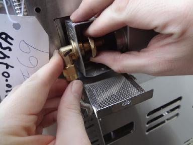 Step 8. Install the left screw into the bracket of the rotisserie burner as it was previously. 19. 20.