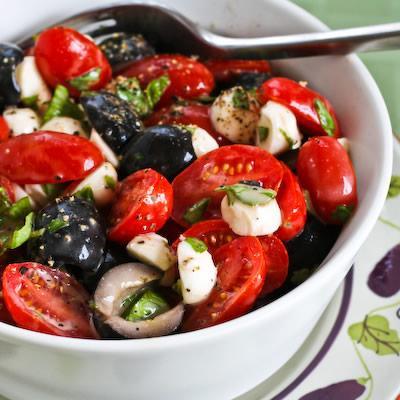 Tomato, Olive, and Mozzarella Salad with Basil Vinaigrette Makes about 4 servings 1 can large black olives, cut in half (6 oz.