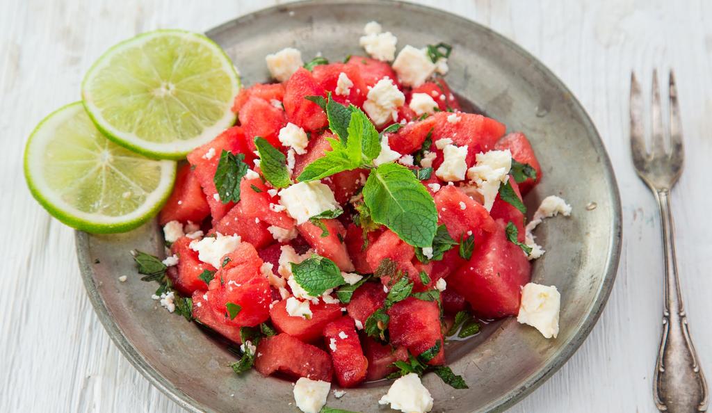 In a small bowl, whisk together extra virgin olive oil, lime and salt and pepper to create a dressing. Place watermelon in a large salad bowl.