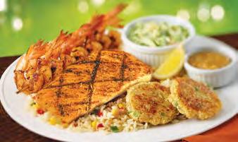 Southwest Salmon Seafood Grilled Seafood Platter Crab cakes, a flaky grilled fish fillet and a skewer of shrimps, dusted with Cajun seasoning served on a bed of rice pilaf with a side of coleslaw and