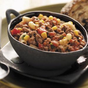 Southwestern Goulash 1 cup uncooked elbow macaroni 1 pound ground beef 1 medium onion, chopped 1 can (28 ounces) diced tomatoes, undrained 2/3 cup frozen corn 1 can (8 ounces) tomato sauce 1 can (4