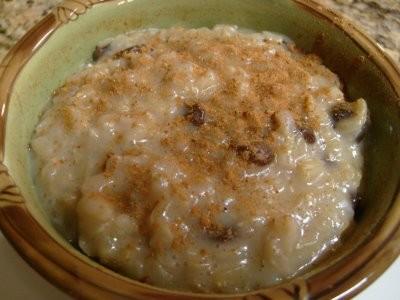 Rice Pudding 1 ¾ cups water ½ cup uncooked brown rice 1 ½ cups 1% low-fat milk ½ cup canned evaporated skim milk 1 egg 2 egg whites ¼ cup sugar 1 teaspoon vanilla extract 1/3 cup raisins ½ teaspoon