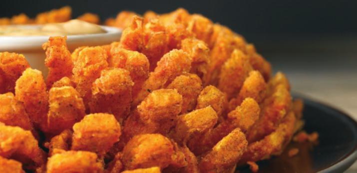 BLOOMIN ONION AUIE-TIZER BLOOMIN' ONION An Outback Original! Our special onion is hand-carved, cooked until golden and ready to dip into our spicy signature bloom sauce. (1950 calories) 9.