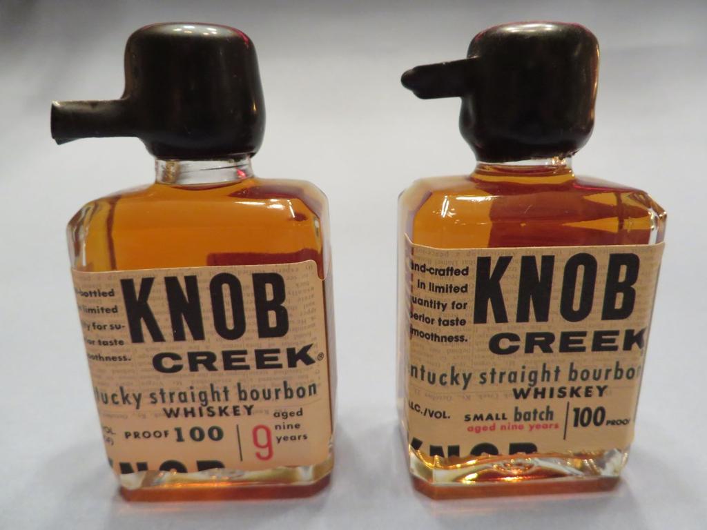 New Knob Creek ( bottle pictured on right ) with minor label