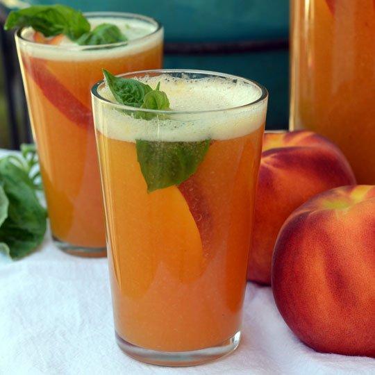 Sparkling Peach Punch Makes about 2 quarts 2 cups water 3 green tea bags 4 large, ripe peaches Juice of 1 lime 4 cups ginger ale Honey or agave nectar to taste A few sprigs of basil or mint Place