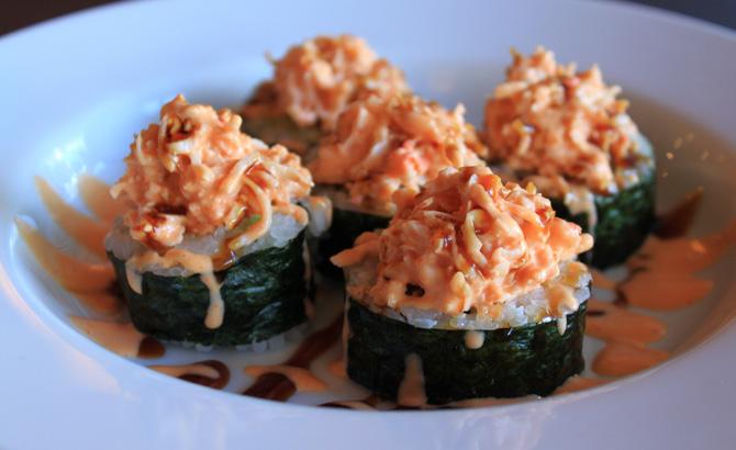 OISHI ROLLS LION KING Crabmeat & avo topped w/ salmon, special mayo sc & g.