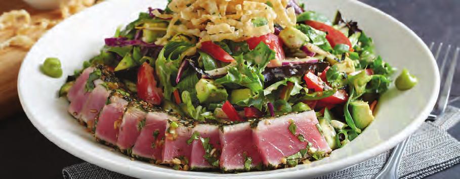 SEARED AHI SALAD* Baby field greens, Napa cabbage, romaine, red bell peppers, tomatoes, avocado, pickled cucumber, cilantro, wasabi, crisp wonton strips and green onions tossed in rice wine