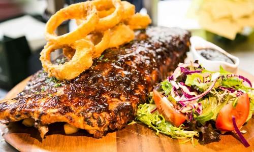 FROM THE GRILL B A R B E Q U E R I B S Irish Times Pork ribs continue to draw the crowds, basted in Irish Times BBQ sauce and grilled until tender. These ribs are taste sensation!