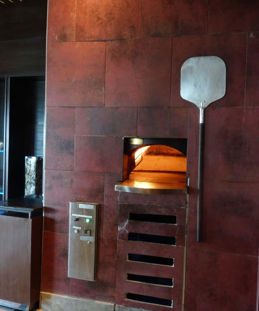 What are Stone Hearth Ovens Why are they popular Spectacular façade finish as a centre point of the restaurant.