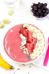 pour into bowls. Top smoothie with sliced kiwi, raspberries, strawberries, banana and a sprinkling of shredded coconut.