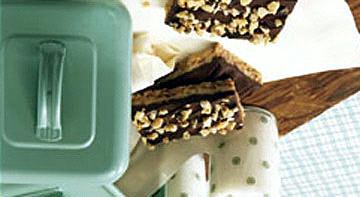 Toffee Bars 1/2 c. butter or margarine, melted and divided 1 c. oats 1/2 c. firmly packed brown sugar 1/2 c. flour 1/2 c. finely chopped walnuts 1/4 tsp. baking soda 1 (14-oz.