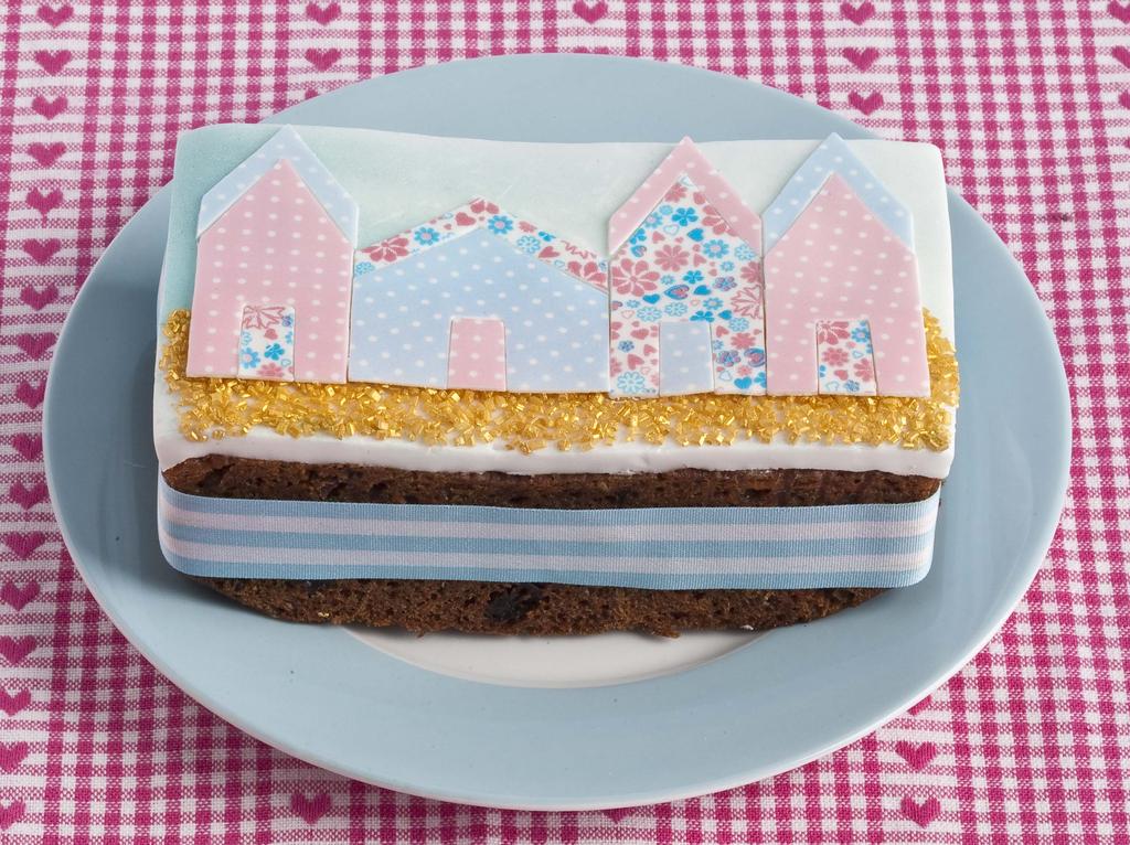 Beach Hut Bar Cake 7 bar cake (we used carrot, but any will do) Butter icing to cover top of cake White sugar paste, rolled out to 6mm Metallic Gold Sparkling Sugar PME Baby Blue Lustre Spray 1 sheet