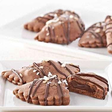 Chocolate Coconut Empanadas Yield: 8 empanadas Prep Time: 30 minutes 2 cup unsalted butter, softened 3 ounces cream cheese, softened - 2 cups powdered sugar 3 cup (2 oz.