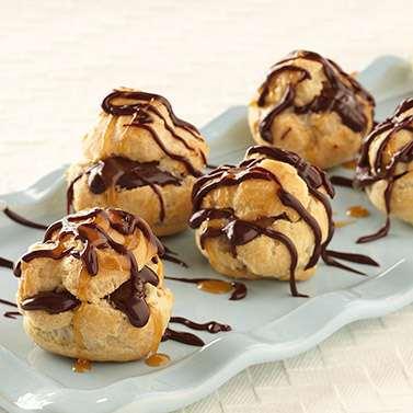 For cream puff dough, in a medium saucepan, combine water, butter, and salt; bring to a boil. Add flour all at once, stirring vigorously. Cook and stir until mixture forms a ball; remove from heat.