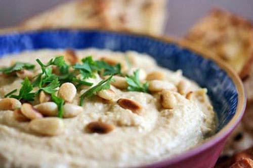 Hummus Recipe Ingredients: 2 garlic cloves, mashed and then minced 2 15-oz cans of garbanzo beans (chickpeas), drained and rinsed 2/3 cup of tahini (roasted, not raw) 1/3 cup freshly squeezed lemon