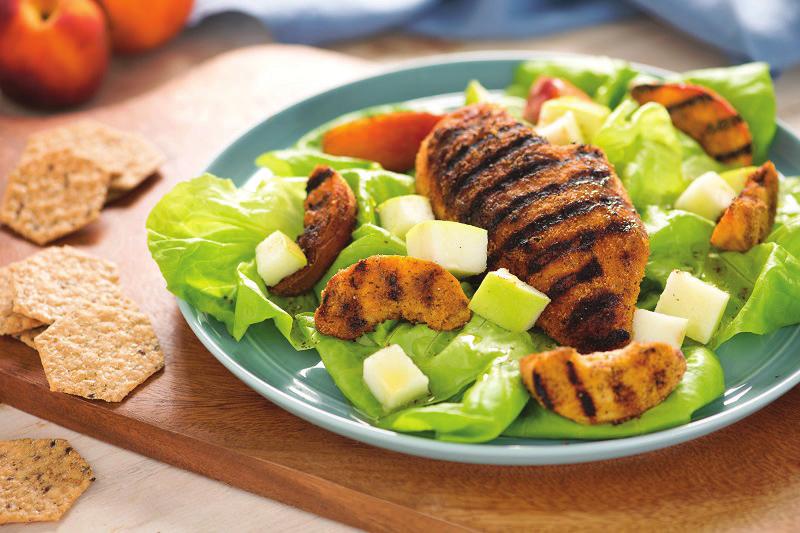 Blackened Chicken with Grilled Peaches 1 cup Crunchmater Multi-Seed Rosemary & Olive Oil Crackers, ground 4 fresh peaches, sliced 1 large apple, chopped 1 head Bibb lettuce, torn 4 skinless chicken
