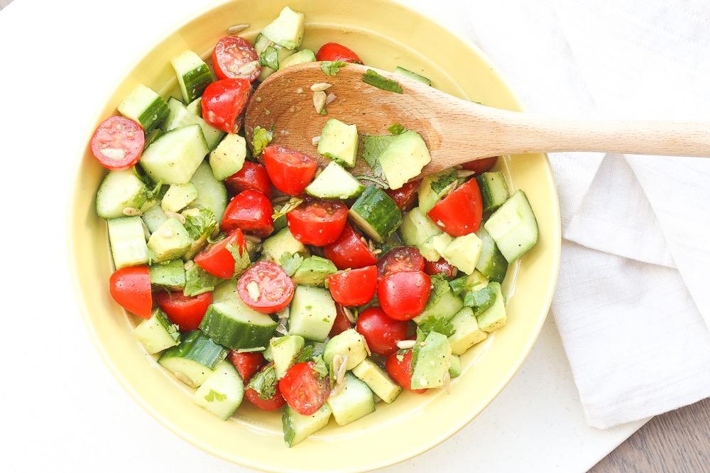 SIMPLE TOMATO CUCUMBER AND AVOCADO SALAD 1 cup grape tomatoes, halved 1/2 English cucumber, sliced and quartered 1 avocado, chopped 1/4 cup cilantro, chopped 1 tablespoon sunflower seeds 3