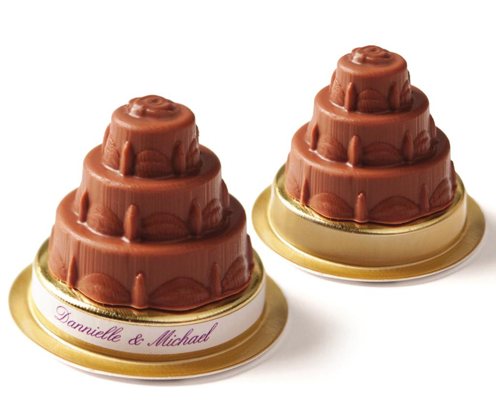 The truffles are packaged with a clear lid (not shown) and sit atop a gold pedestal.