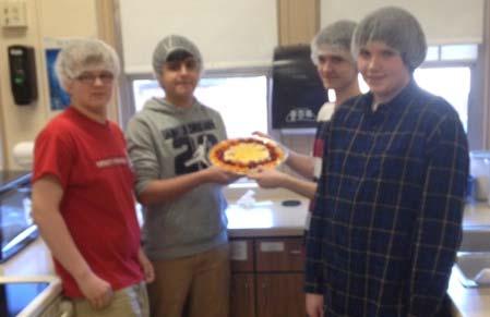 Wilson Jr High School Page 2 of 2 Brett, Alexis, Austin and Chris proudly display the fruit pizza they crafted on a bed of marscapone cheese.
